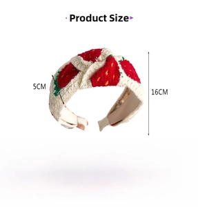 Detail view of the embroidered strawberry knit headband showing dimensions and fabric texture