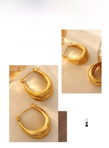 Detail shot of golden chunky hoop earrings featuring vintage croissant textured ridges