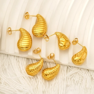 Three pairs of 18k gold teardrop earrings with hammered and textured stainless steel finishes