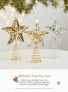 Detailed view of gold and silver iron Christmas tree toppers with hollow deer and star designs