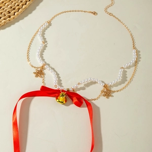 Detailed Christmas choker with red velvet bow, golden bell and snowflake charms