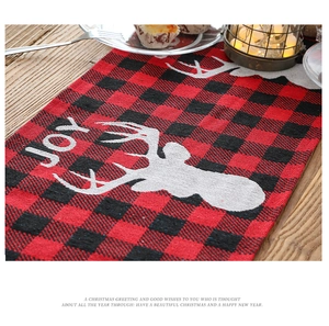 Detail of red and black buffalo plaid Christmas table runner with elk and JOY print