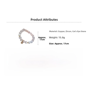 Detail view of pink cat eye stone bead bracelet with gold star charm and zircon accents