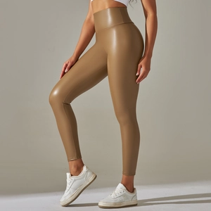 Side view of high-waisted brown faux leather leggings with matte finish on female model