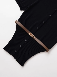Detail of black knit cardigan texture featuring front buttons and brown leather belt