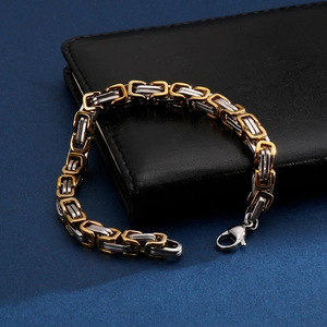 Detail of two-tone gold and silver Byzantine chain bracelet with a lobster clasp