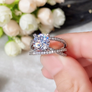 Macro shot of silver crisscross ring with a round zircon stone and small pave diamonds