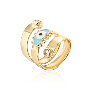 Detailed view of gold spiral ring with blue evil eye enamel and white zircon accents