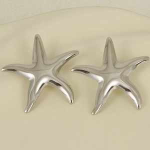 Detailed view of silver starfish studs in 304 stainless steel on a textured background