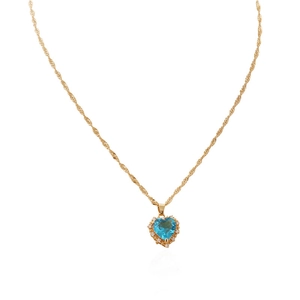 Detail of gold heart necklace featuring a sky blue crystal with pavé zircon borders