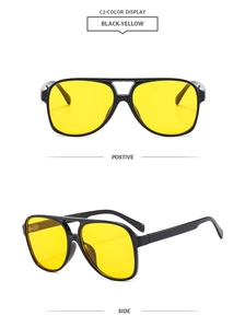 Detail view of classic pilot sunglasses with double bridge frame and yellow lenses