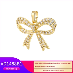 Detail view of gold brass bow pendant with zircons and MAMA inscription charm