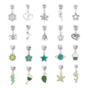 Macro shot of 20 assorted silver alloy charm pendants featuring floral and nature motifs