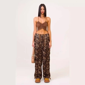 Women's leopard print satin wide leg cargo pants with a brown ruched camisole top
