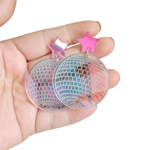Detail of pink mirror star earrings with iridescent acrylic disco ball pendant hanging