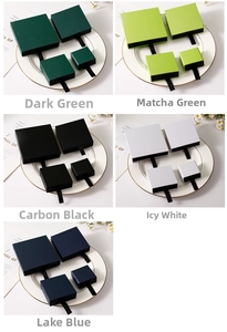 Detail view of square drawer jewelry gift boxes in five colors with black ribbon pulls
