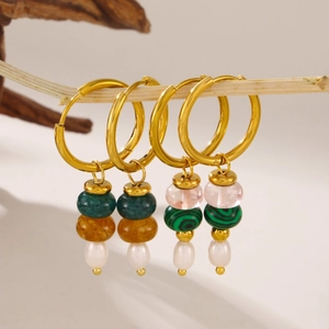 Stainless steel hoop earrings with colorful natural stone and pearl tassels on wood
