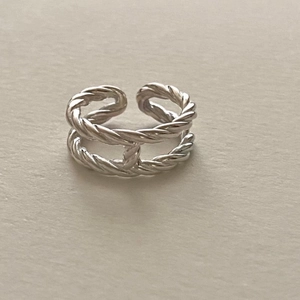 Close-up of double-layered twisted silver ring with H-shaped geometric connecting bridge