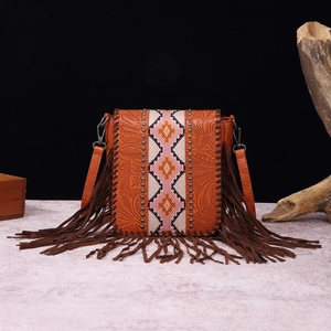 Close-up of Bohemian leather crossbody bag with floral embossing and colorful tribal strap
