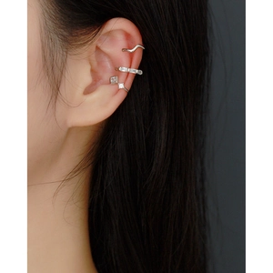 Close-up of three S925 silver ear cuffs with clear stones worn on a model's ear