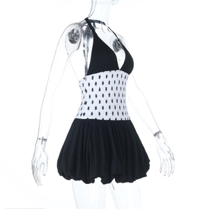 Detailed view of the elastic polka dot waist and pleated black bubble skirt hemline