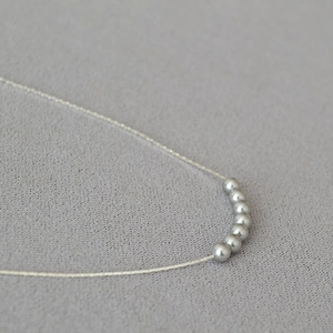 Minimalist pearl necklace with seven silver round beads on a fine chain for women