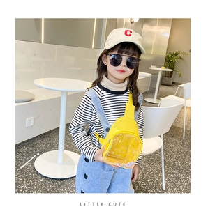 Detail of yellow kids chest bag featuring a heart-shaped window with colorful flowing sequins