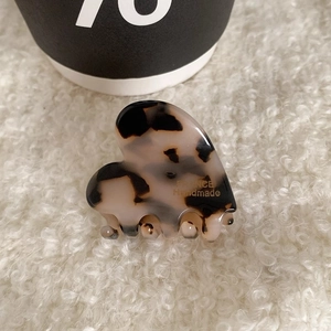 Close-up of tortoise shell heart hair claw with golden France Handmade text logo