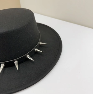 Detailed macro view of black punk style wool fedora hat with silver spikes decoration