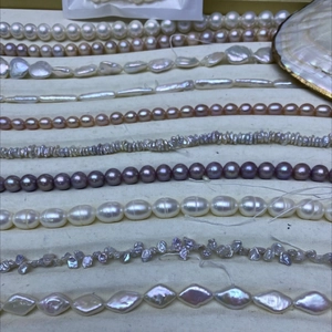 Close-up of assorted Baroque freshwater pearls in multiple colors on a velvet display