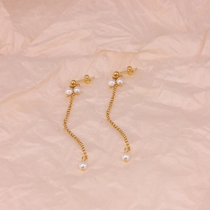 S925 sterling silver chain tassel earrings with pearls on soft pink fabric background