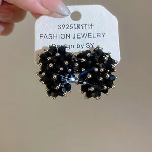 Handheld view of S925 silver stud earrings with faceted black crystal beads