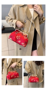 Detailed view of red embroidery bag with golden frame, pearl chain, and silk tassel