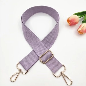 Detail of light purple adjustable canvas bag strap with gold-tone alloy buckles
