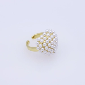 Close-up of elegant gold open ring featuring a cluster of lustrous white faux pearls