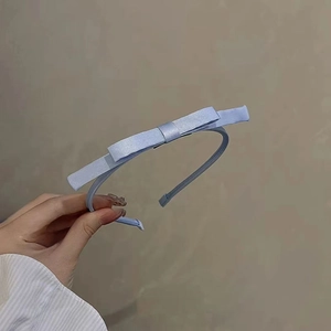 Elegant blue satin bow headband for women featuring a minimalist and sweet princess style