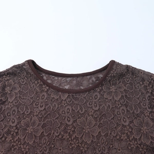 Close-up of the delicate lace neckline detail on a slim-fit brown long-sleeve dress