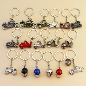 Collection of metal motorcycle and helmet keychains in various colors and styles