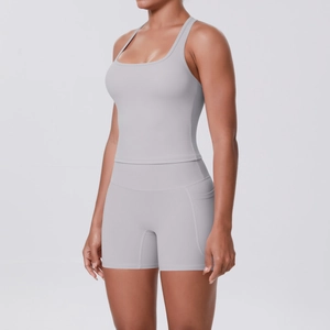 Detail showing side pocket of light grey high-waist fitness shorts and racerback sports top