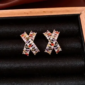 Exquisite 18k gold plated X-shaped earrings featuring multi-color baguette cubic zirconia