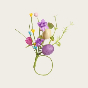 Easter napkin ring with purple eggs, artificial flowers and green plants on a white background