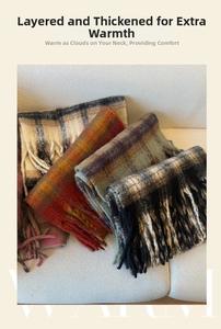 Detail of thick plaid scarves with long tassels in earthy tones for autumn and winter