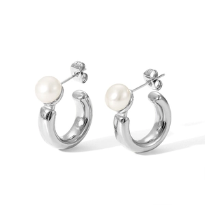Close-up of C-shaped stainless steel earrings with elegant white spherical pearls