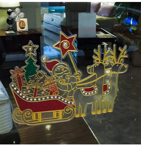 Close-up of Santa Claus and reindeer static window stickers with golden glitter accents