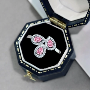 Close-up of S925 silver ring with three pink pear-cut stones in a blue gift box