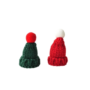 Mini knitted Christmas hats set in festive red and green yarn for holiday decorations