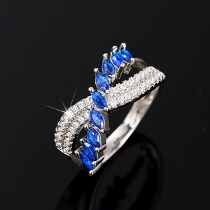 Macro detail of royal marquise blue sapphires and clear diamonds on silver ring band