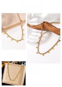 Detail of gold-plated star charm necklace with sparkling cubic zirconia on a chain