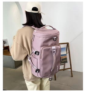 Rear view of a light purple waterproof nylon travel backpack with top handle and side buckle