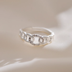 Close-up of adjustable silver chain ring with pavé micro-set cubic zirconia crystals